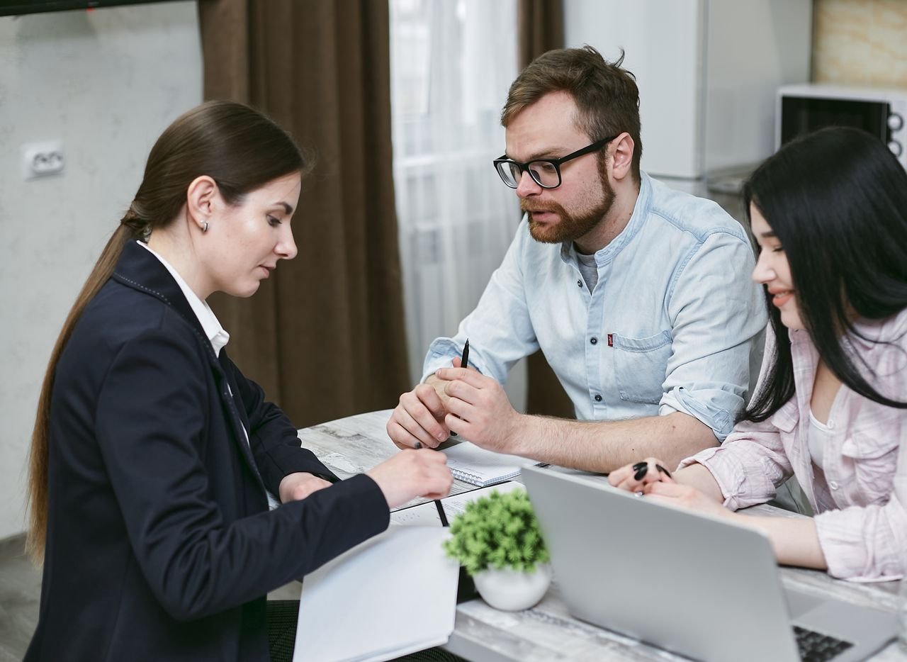 Mastering the First Impression: Your intriguing post title goes here A couple discusses financial documents with their advisor, highlighting investment strategies.